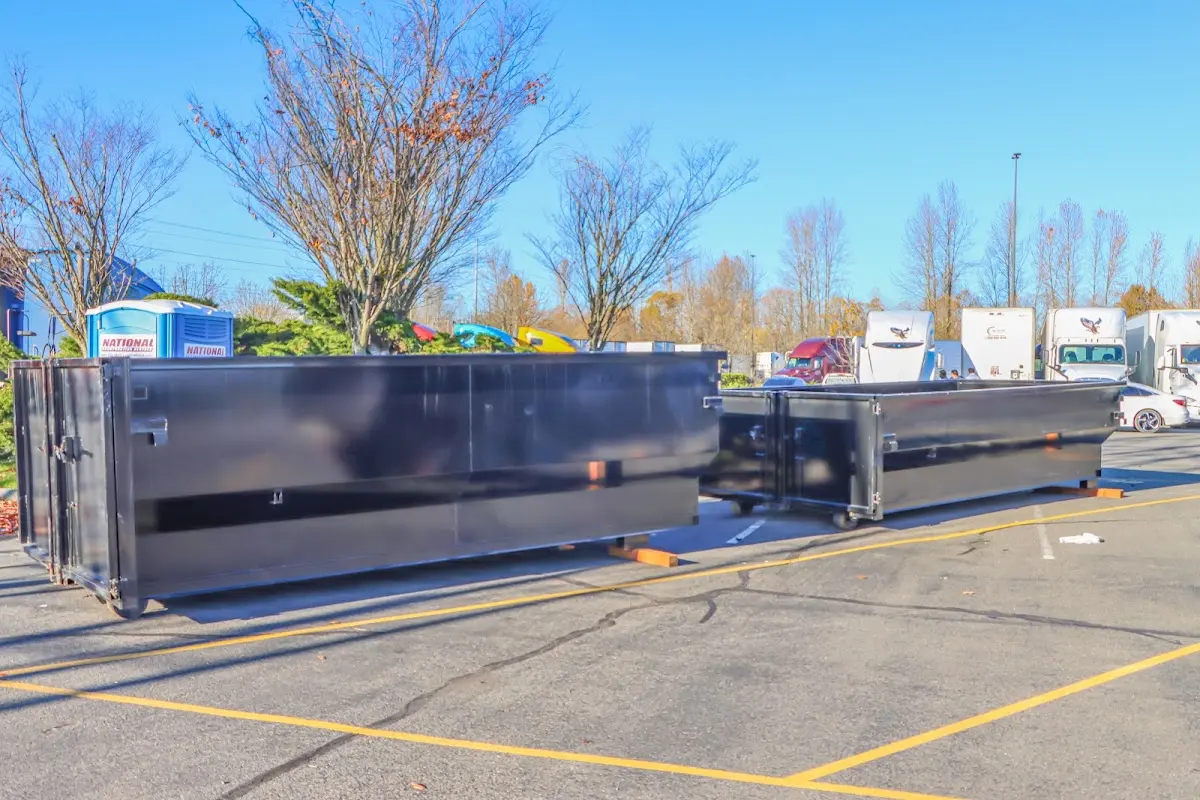 Professional dumpster rental service with roll-off container on residential driveway in Smithfield